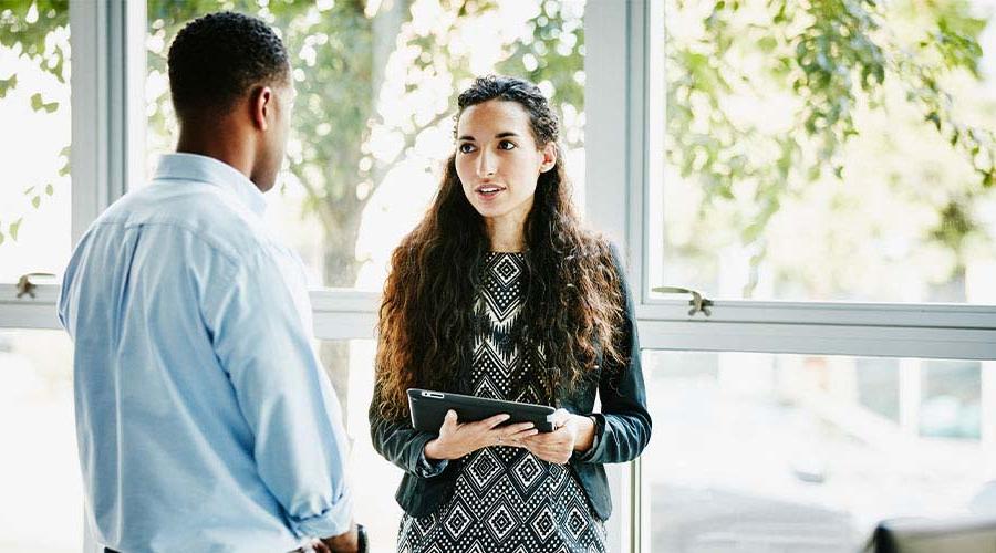 Male and female employee in conversation